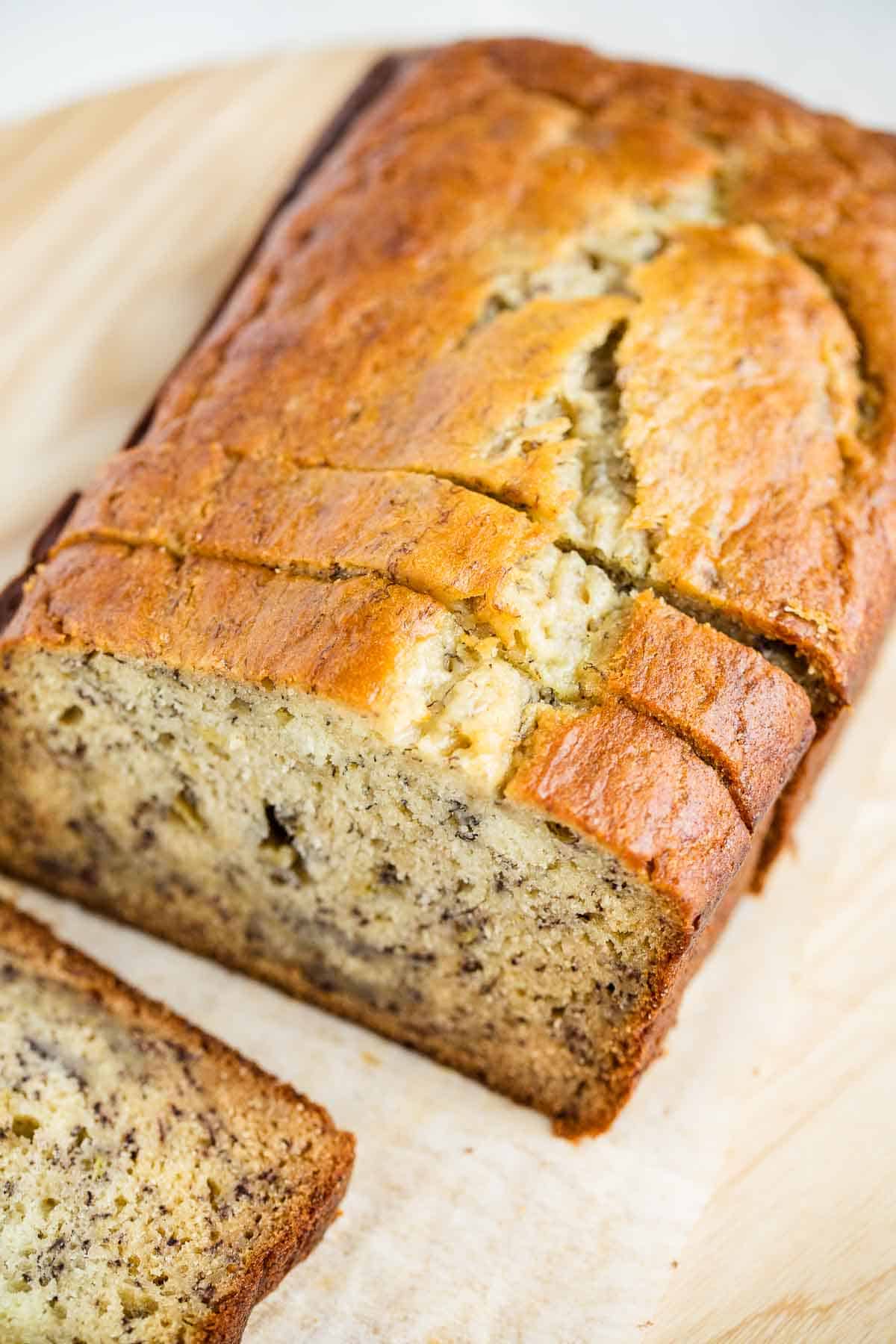 Sliced banana bread on a wooden board.