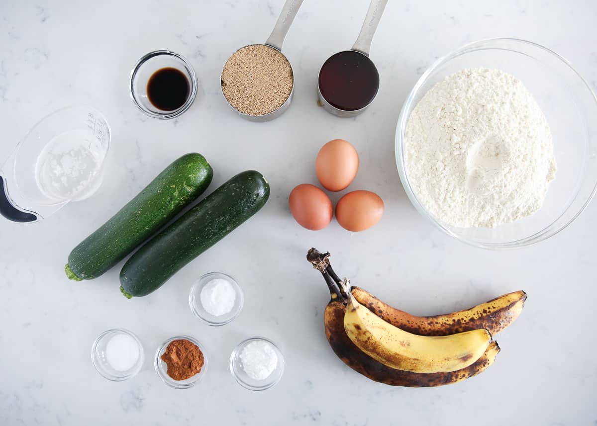 Banana zucchini muffin ingredients on counter.