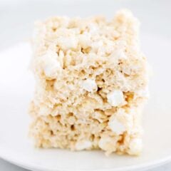 A stack of three brown butter rice krispie treats on a plate.
