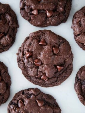 Double chocolate chip cookies on a marble countertop.