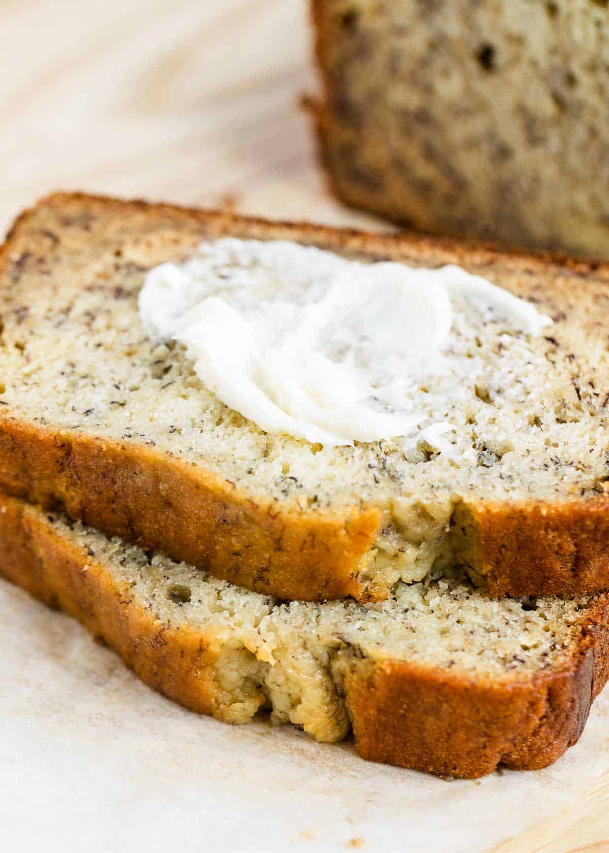 Sliced banana bread with butter on top. 