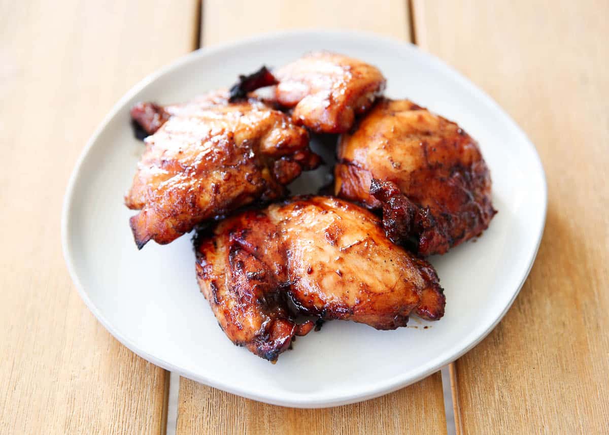 Grilled chicken thighs on a plate.