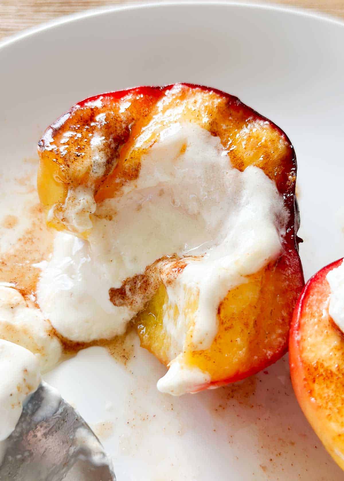 Grilled peaches with cream on top.