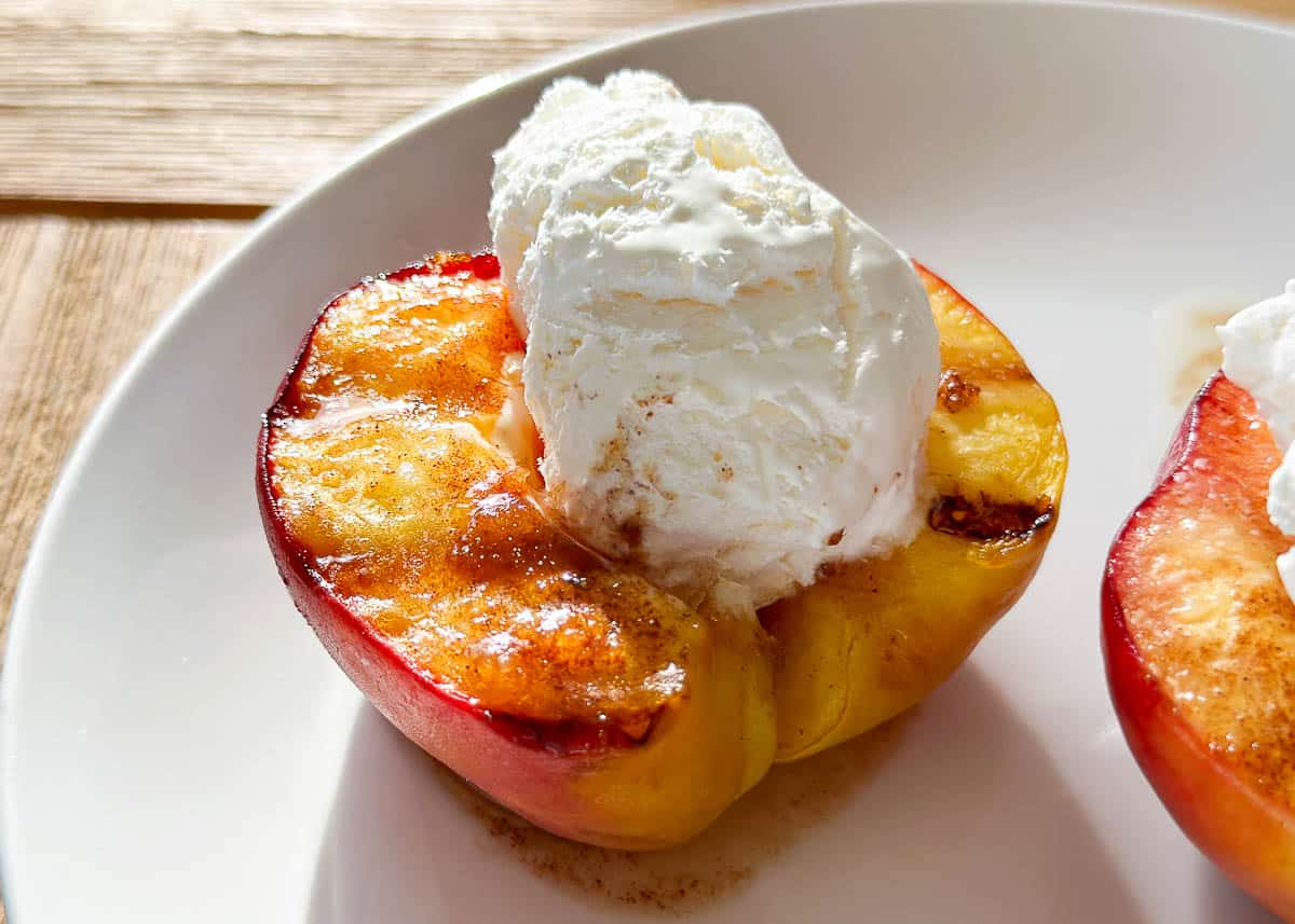 Grilled peach with cream on top.