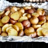 Grilled potatoes cooking in foil.