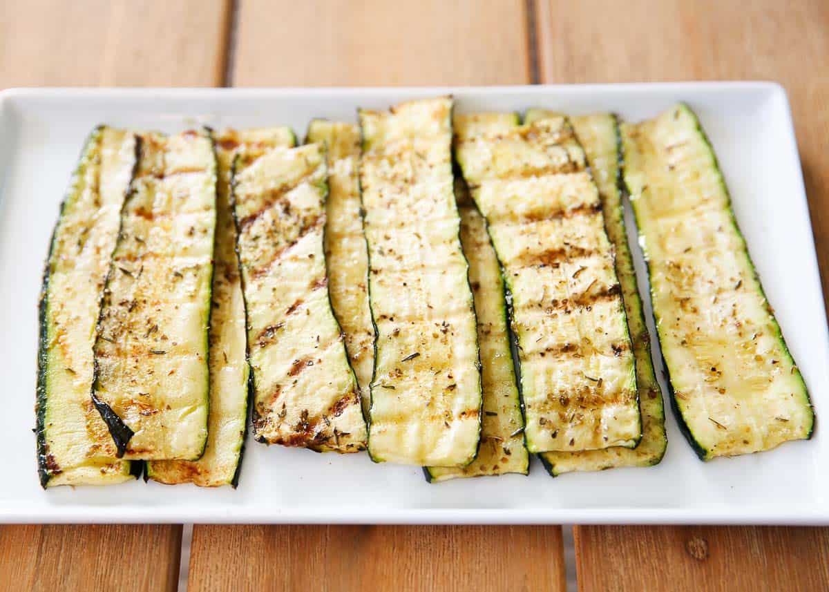 Grilled zucchini on a white plate.