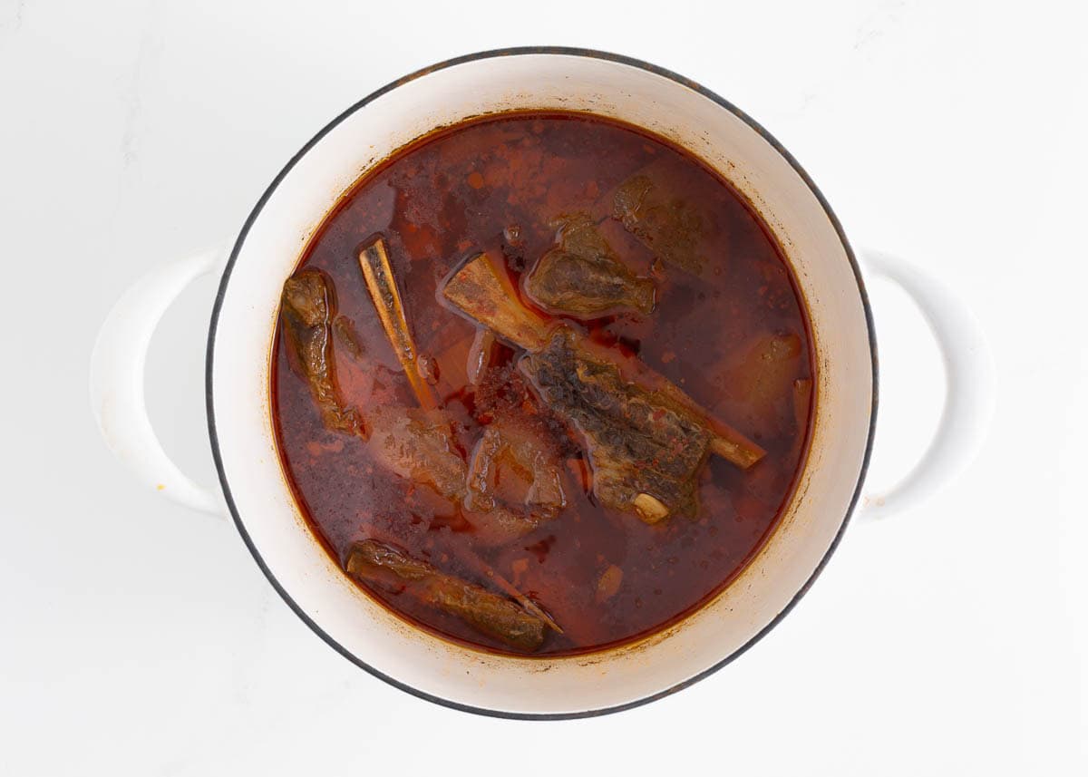 Beef birria in a white pot.