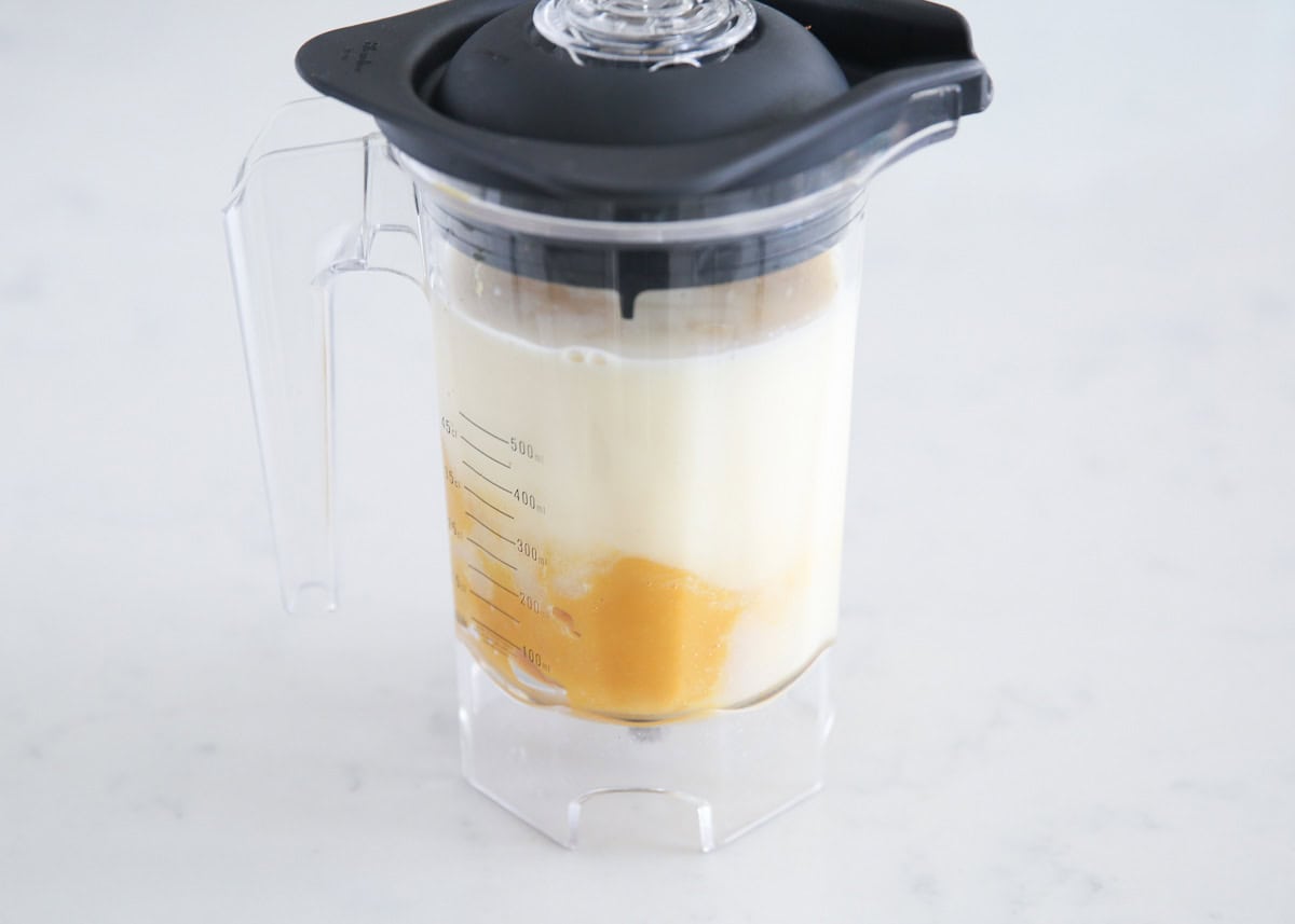 Orange juice concentrate, milk, vanilla, and sugar in a blender.