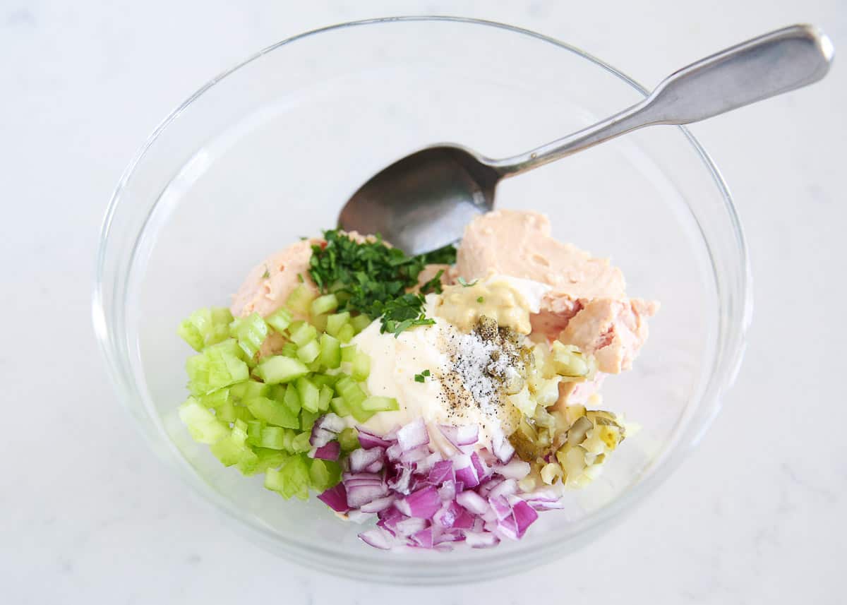 Making tuna salad in bowl.