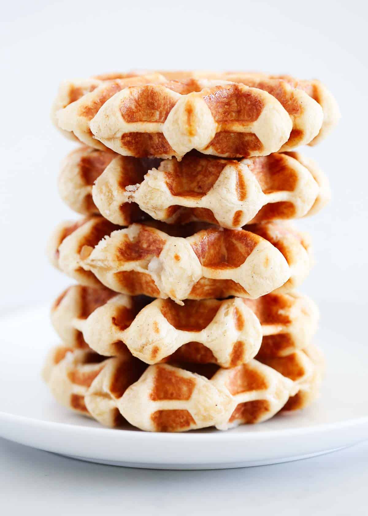Stack of liege waffles on a white plate.