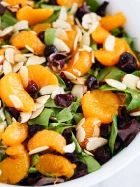 Mandarin orange salad with leafy greens, cranberries, and almonds, tossed in homemade orange dressing.