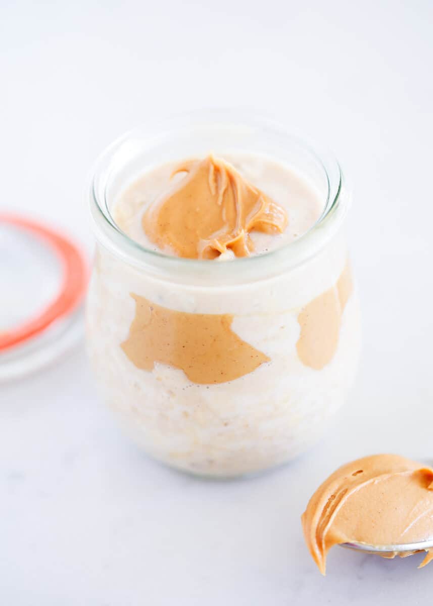 Peanut butter overnight oats in a jar with peanut butter on top.