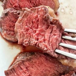 Slice of sirloin steak with a fork.