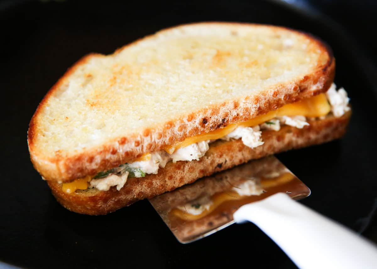 Tuna melt cooking in skillet.