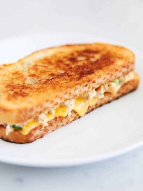 Tuna melt on a white plate.