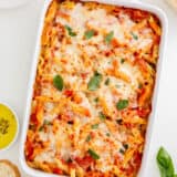 Mostaccioli baked in a white dish.
