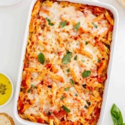 Mostaccioli baked in a white dish.