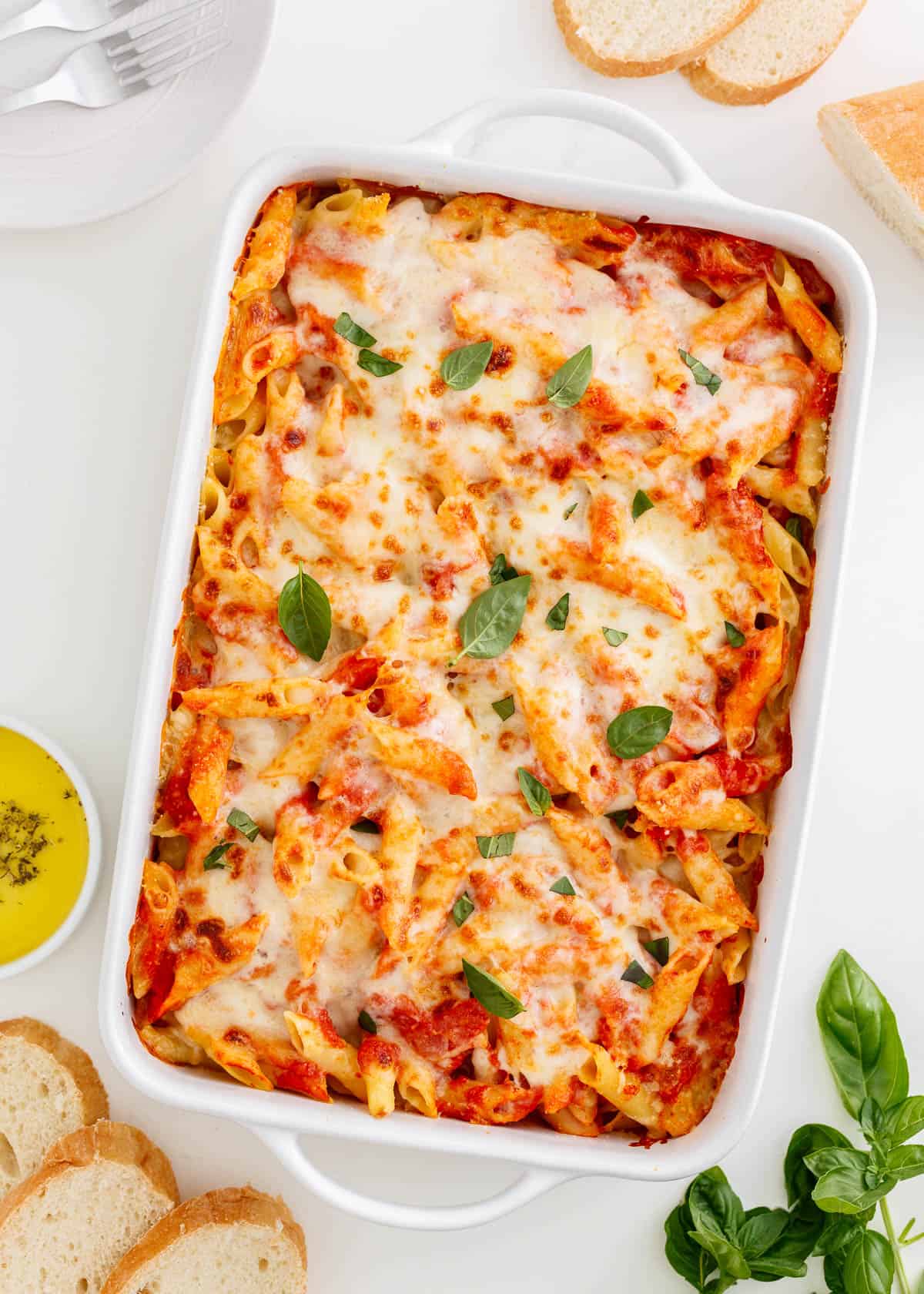 Mostaccioli baked in a white dish.
