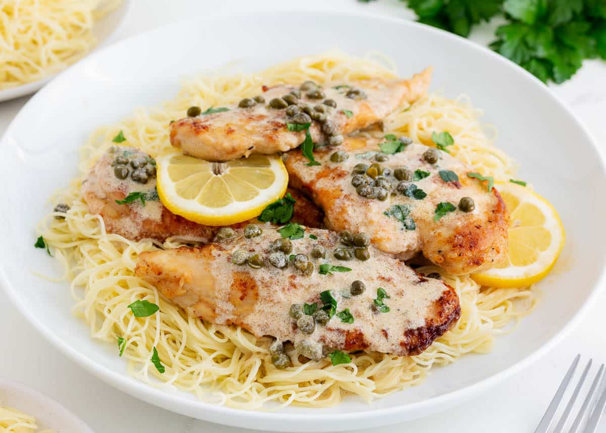 Chicken piccata and pasta in a bowl.