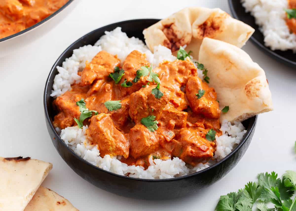 Chicken tikka masala and rice in a bowl.