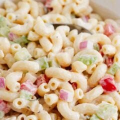 Easy macaroni salad in a white bowl with a spoon.