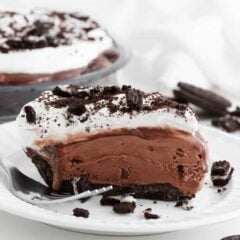 Frozen slice of mud pie on a plate with a fork, perfect summer dessert.