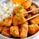 Orange chicken and rice in a bowl.