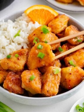 Orange chicken and rice in a bowl.