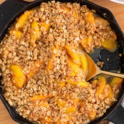 Peach crisp cooked in a iron skillet.