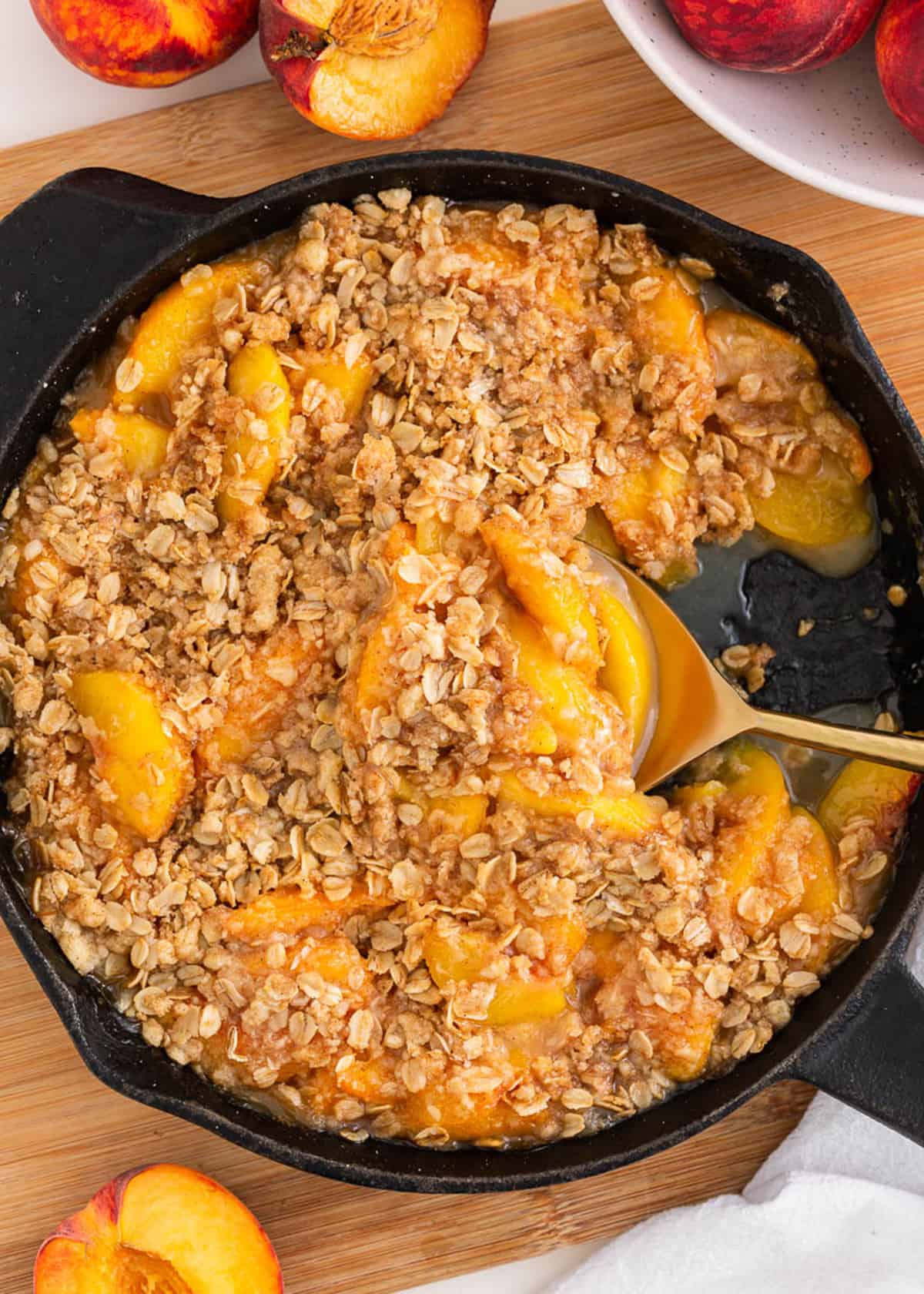 Peach crisp cooked in a iron skillet.