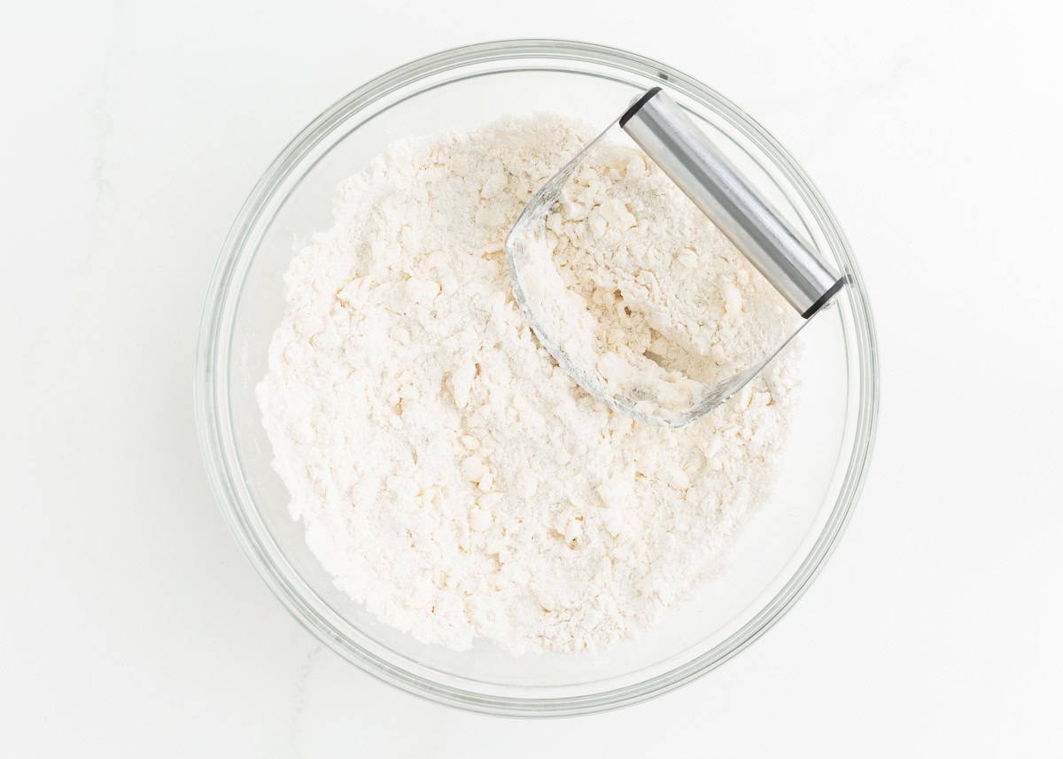 Flour and cold butter in a bowl with pastry cutter.