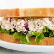 Tuna salad between two slices of bread.