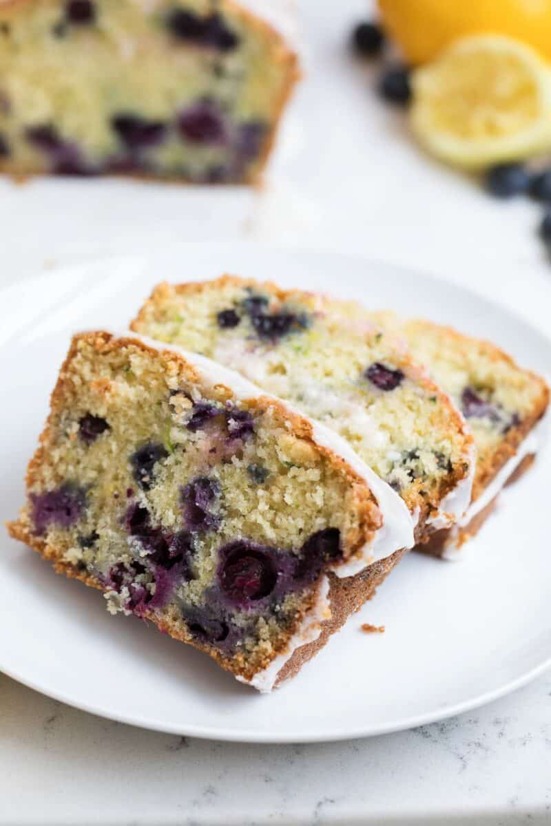 Sliced lemon blueberry zucchini bread on a plate.