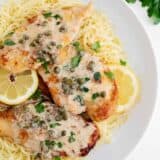 Chicken piccata and angel hair pasta in a bowl.