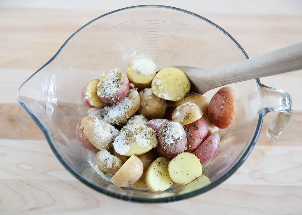 Potatoes in a bowl with seasoning.