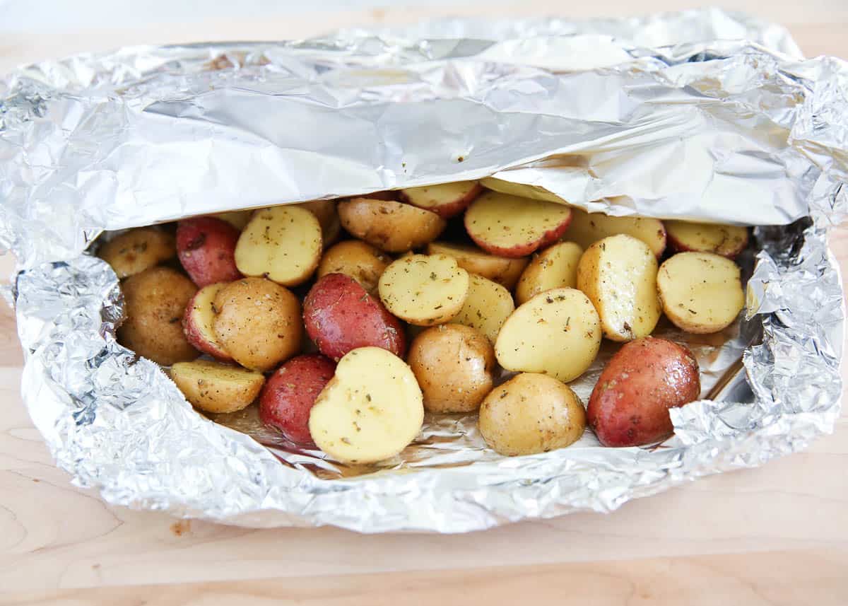 Grilled potatoes in foil pack with top piece of foil folded back.