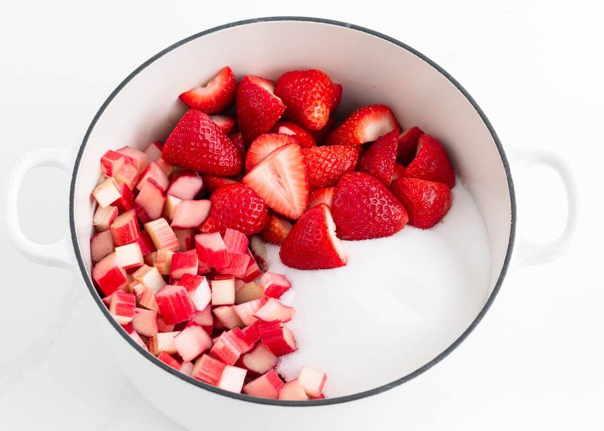 Strawberries, rhubarb and sugar in a pot.