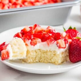 A slice of strawberry shortcake bars on a plate, a favorite strawberry dessert for summer.