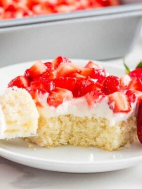 A slice of strawberry shortcake bars on a plate, a favorite strawberry dessert for summer.