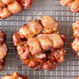 Apple fritters on a cooling rack.