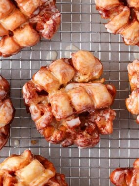 Apple fritters on a cooling rack.