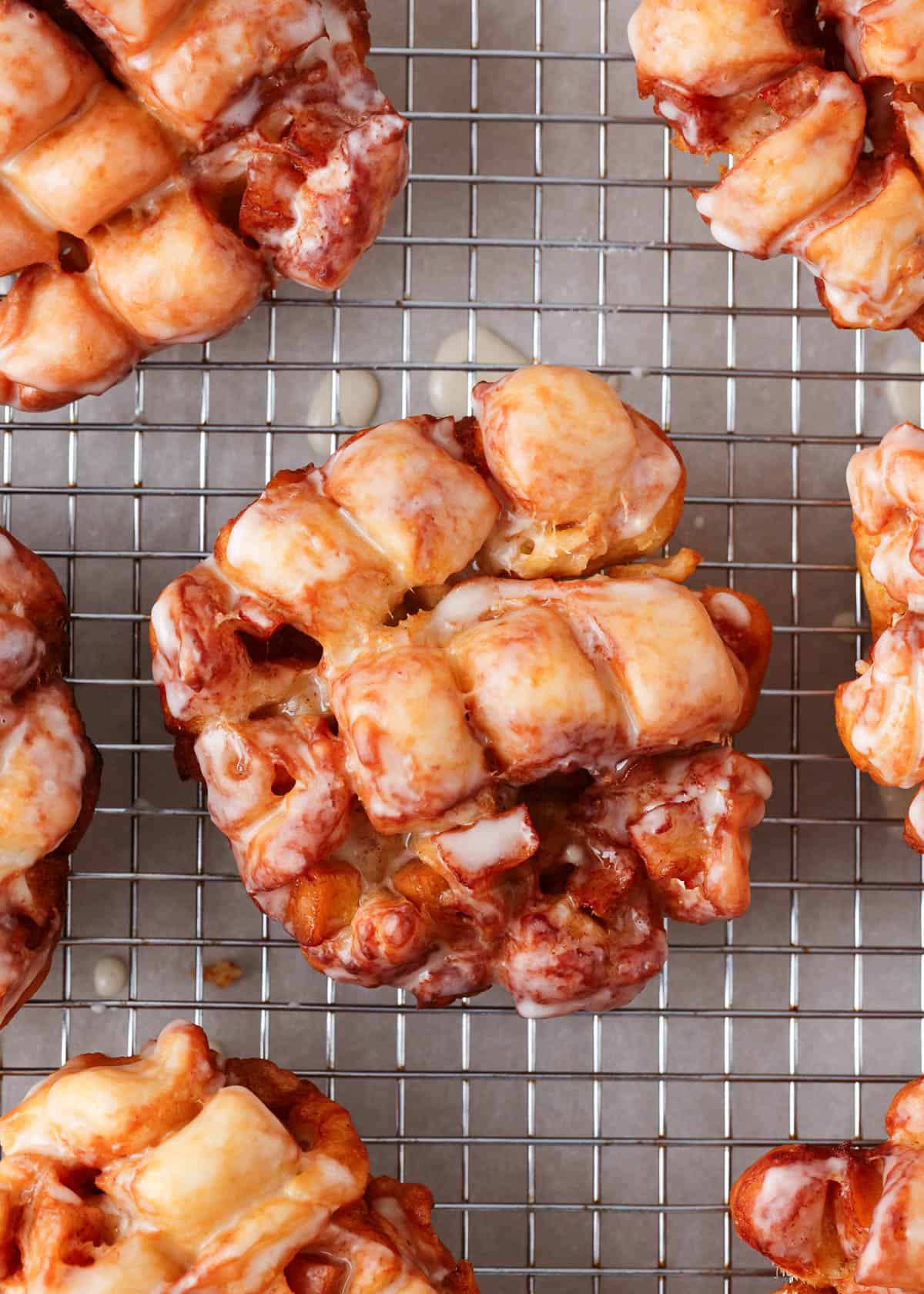 Apple fritters on a cooling rack.