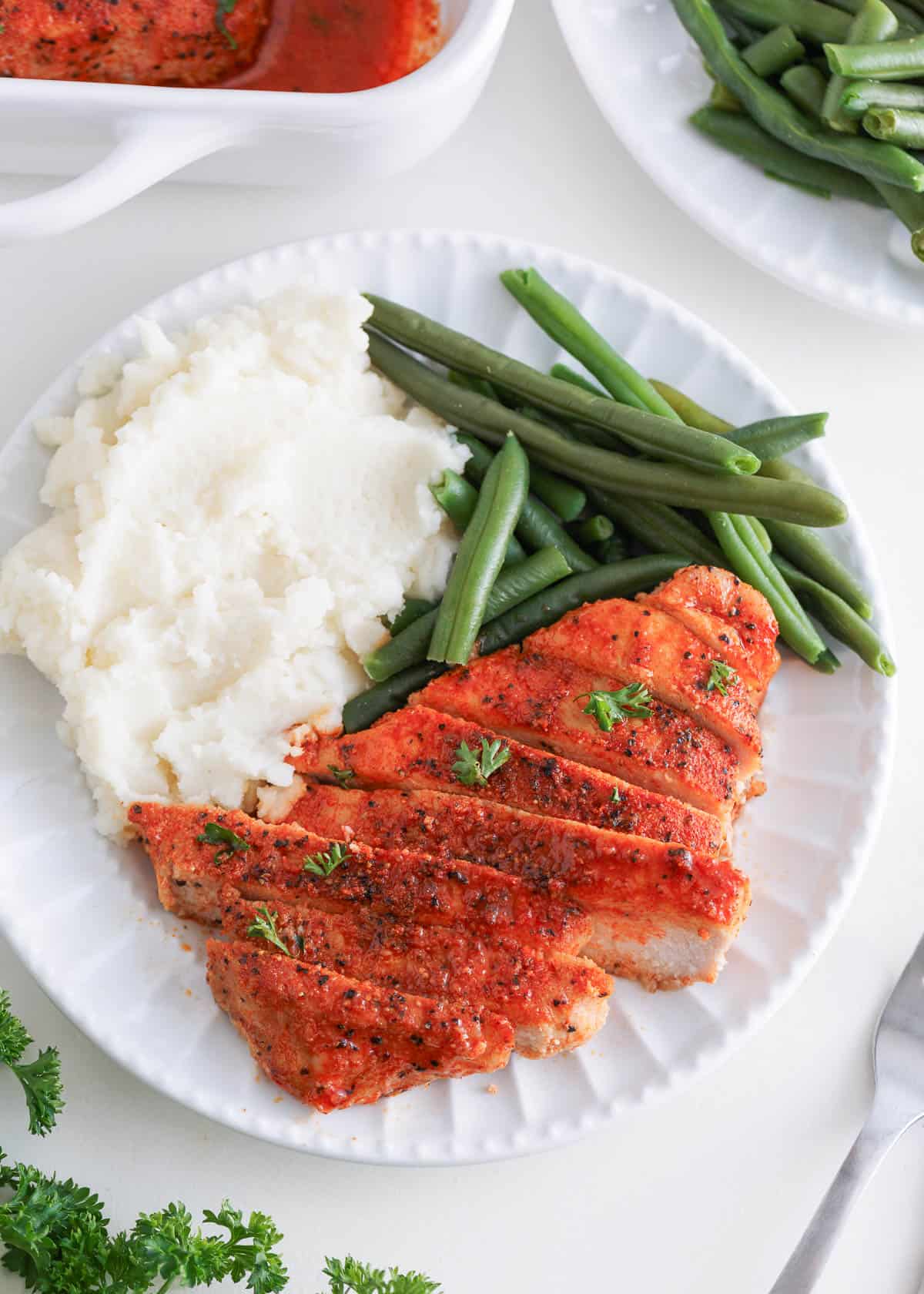 Pork chops with mashed potatoes and green beans.