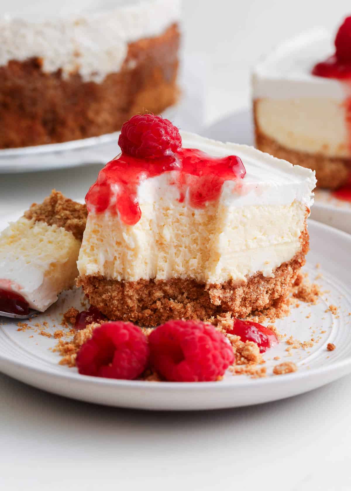 Slice of cheesecake with raspberry sauce on top.