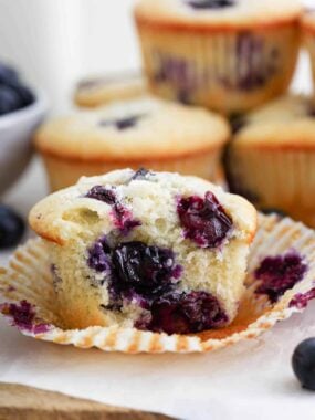 Bite taken from a blueberry muffin.