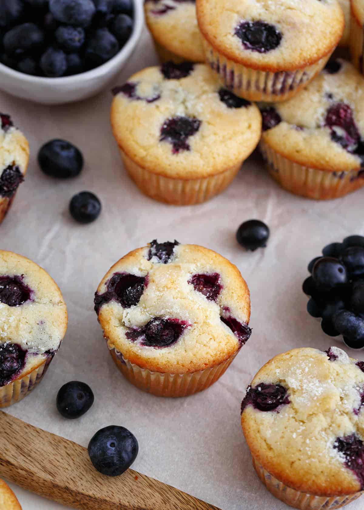Blueberry muffins on wooden board.
