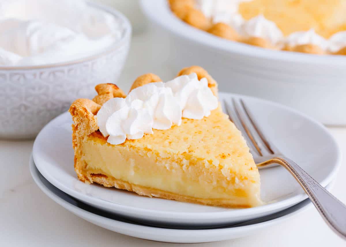 Slice of buttermilk pie on a white plate.