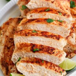 Sliced chicken breast on a white plate.