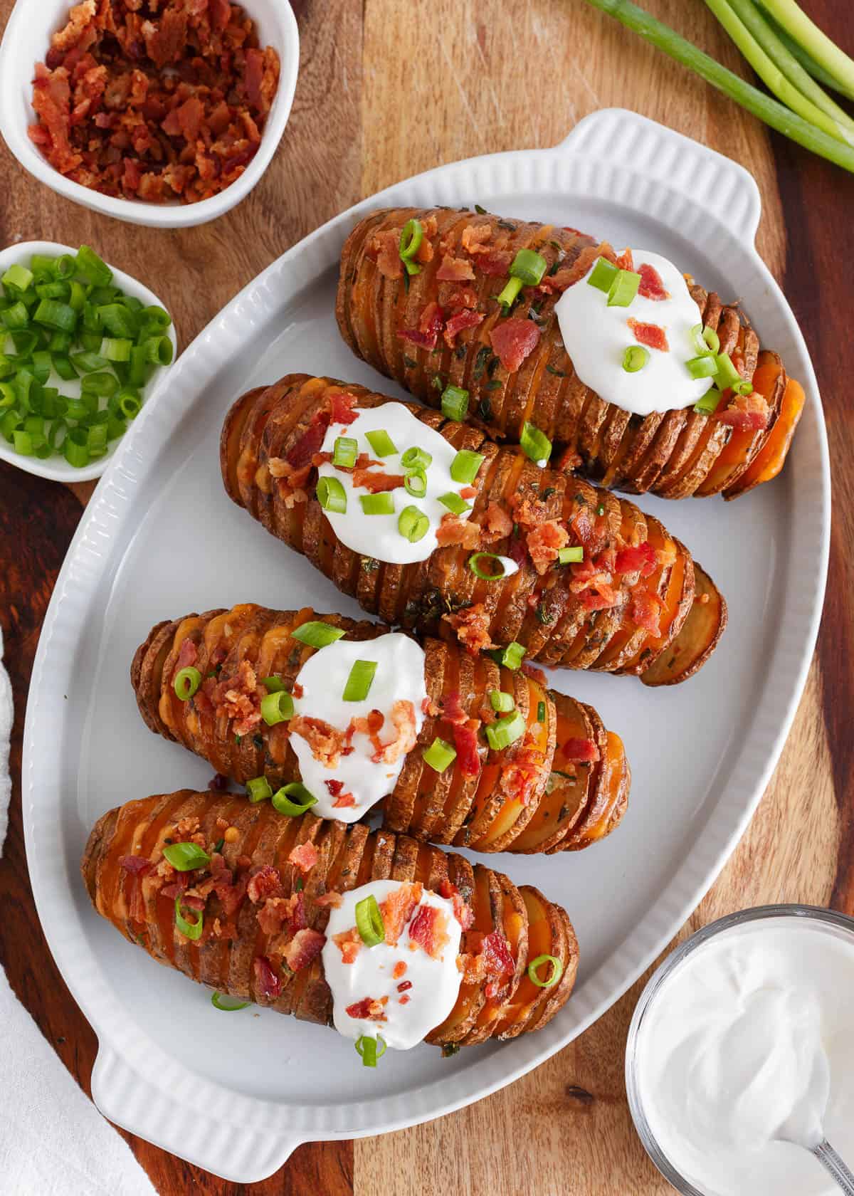 Hasselback potatoes on a white plate.