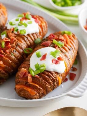 Hasselback potatoes with sour cream on top.